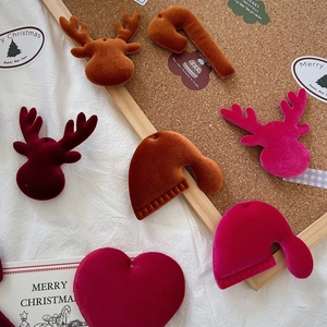 Detailed view of velvet Christmas reindeer, hat, and heart ornaments for DIY crafts
