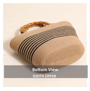 Detailed bottom view of the woven straw bag with bamboo handle and black stripes
