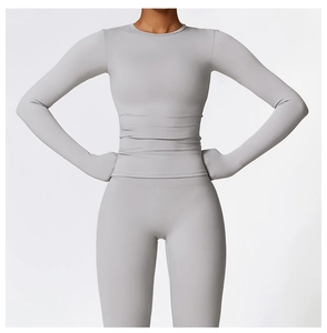 Close-up of matte light gray high-stretch long sleeve yoga top with tight compression fit
