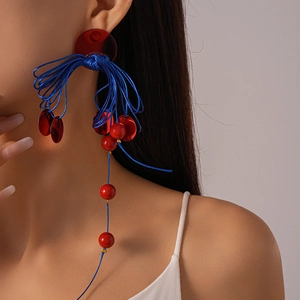 Ethnic style long tassel drop earrings with red resin beads and blue knotted rope design