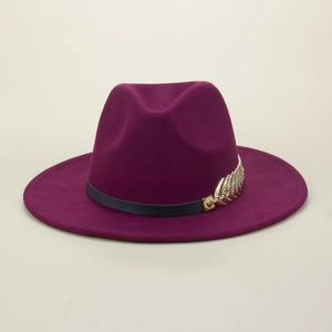 Detail of burgundy wool fedora hat featuring a black leather band and gold leaf metal accent