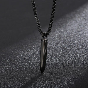 Macro shot of a sleek black bullet pendant necklace made of high-quality titanium steel