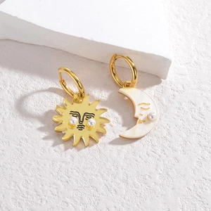 Asymmetric celestial earrings with gold sun and moon pendants and pearl accents