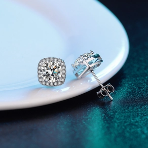 Macro shot of square 925 silver stud earrings with D color moissanite on ceramic plate
