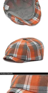 Détail d'une casquette plate à carreaux orange montrant le tissu et l'étiquette de lavage