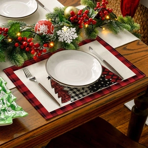 Close-up of Christmas placemat with tree pattern on rustic table with festive decor