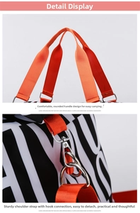 Detail of reinforced orange webbing handles and silver metal hooks on a travel bag