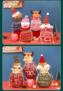 Detail of knitted and burlap Christmas drawstring gift bags with 3D festive characters