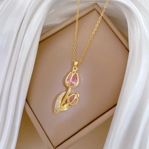 Luxury gold tulip flower necklace with pink crystal pendant on jewelry box display