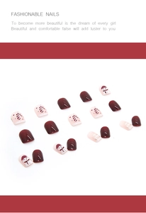 Detailed view of red Christmas press-on nails featuring hand-painted snowman and candy canes