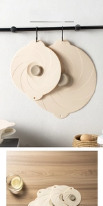 Macro detail of beige silicone food covers with spiral texture and storage hanging loop