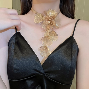 Close-up of golden multi-layer mesh flower tassel necklace on a female model