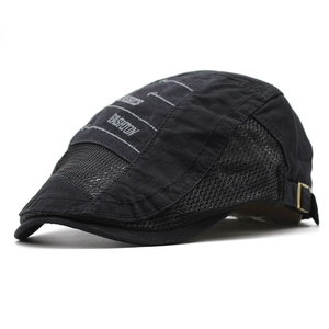 Detail of black mesh beret cap with fashion embroidery and adjustable metal side buckle