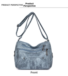 Front view of multi-pocket washed canvas crossbody bag in blue with adjustable strap