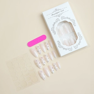 Detail of French white rhinestone press-on nails set with mini file and adhesive tabs