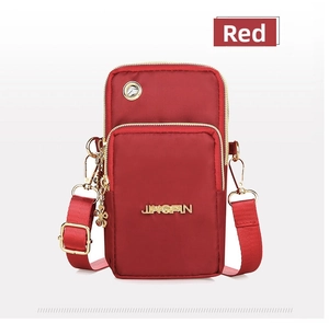 Detail of red nylon crossbody phone bag featuring a metal logo and dual zipper pockets