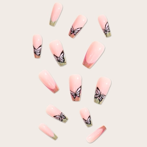Long coffin nude pink press-on nails featuring butterfly patterns and golden glitter details