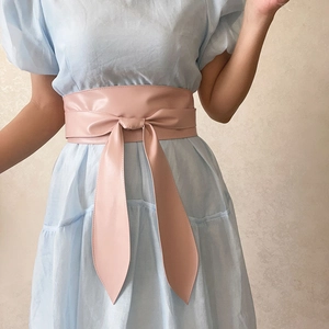 Détail de la ceinture corset rose en cuir PU avec un grand nœud décoratif sur robe