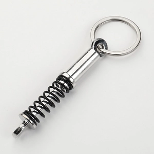 Silver and black car shock absorber keychain with realistic metal spring and ring