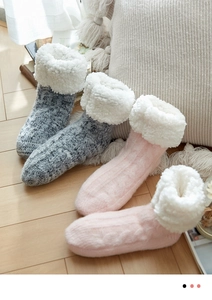 Close-up of thick thermal knit house socks with warm fleece lining in grey and pink