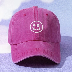 Unisex washed cotton baseball cap in hot pink featuring a street-style smiley embroidery