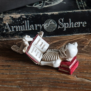 Creative skeleton figurine reading a book on a vintage desk for Halloween decor