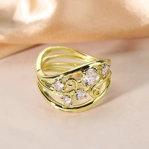 Detailed macro view of vintage hollow leaf ring with sparkling zircon stones in gold finish