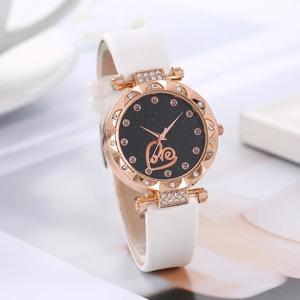 Detail of rose gold watch case with crystal inlay and starry dial with love motif