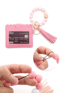 Detail shot showing the high elasticity and durable stretch of the pink beaded wristlet