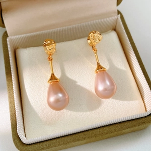 Elegant teardrop pearl earrings in a luxury green velvet jewelry gift box