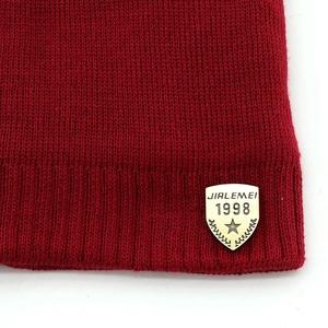 Deep red knit beanie and scarf set with gold emblem for men's winter warmth