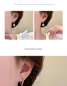 Detail view of elegant French style gold pearl drop earrings worn by a model