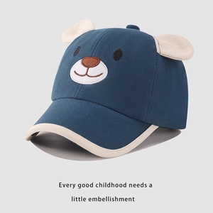 Detail of embroidered cartoon bear face and 3D ears on cotton kids baseball cap