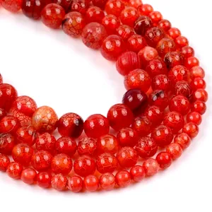 Macro shot of red agate round beads with unique dragon vein patterns and crackle finish