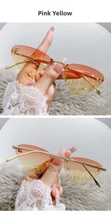 Detail of rimless cat-eye sunglasses with gradient pink-yellow lenses and F-shaped metal trim