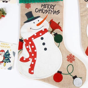 Detailed jute Christmas stocking with snowman embroidery and green knitted cuff decoration
