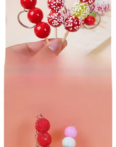 Detailed macro view of realistic mini candied fruit skewers with colorful resin finish