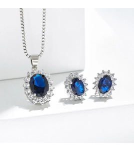 Macro shot of silver jewelry set with blue oval gemstones and white diamond halo