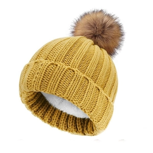 Fleece-lined knit beanie in ginger yellow with a faux fur pom pom for warmth