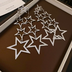 Exaggerated silver star tassel drop earrings featuring layered hollow pentagram metal design