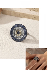 Macro detail of S925 sterling silver evil eye ring featuring blue and white zircon stones
