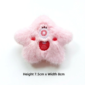 Pink star-shaped plush monster doll brooch with one-eye embroidery and soft fur texture