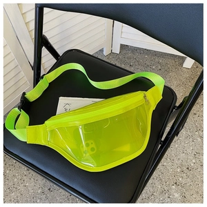 Detail of neon green transparent PVC fanny pack featuring a black buckle strap