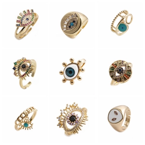 Set of golden evil eye rings with colorful zircon and enamel in minimalist style