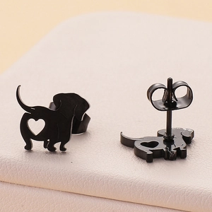 Macro view of black stainless steel dachshund earrings with hollow heart detail