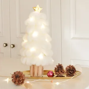 Mini cotton ball Christmas tree with warm LED lights on a wooden base and gold star