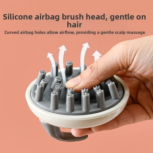 Detail of soft silicone scalp massage brush with air cushion showing flexible pressing action