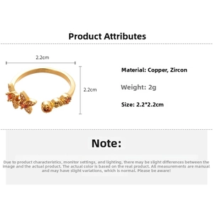 Detail view of 18k gold plated copper ring with butterfly design and orange zircon
