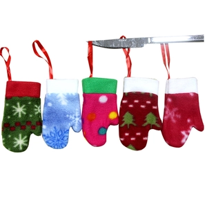 Detailed view of colorful Christmas glove cutlery holders with hanging ropes