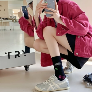 Stylish crew socks with colorful paint patterns paired with casual sneakers in a street look